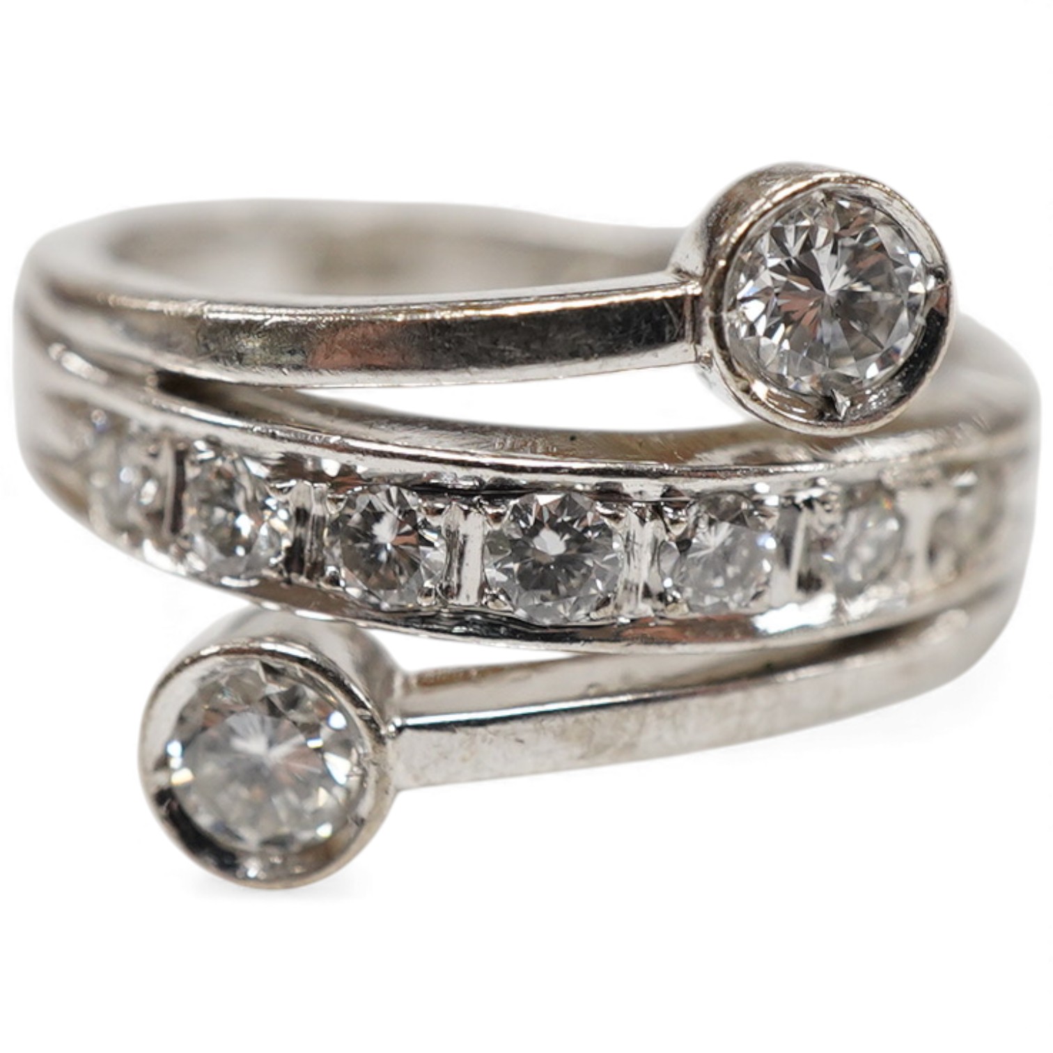 A recent 14k white metal and diamond ring, the ring head designed as three bands, central row of seven graduated diamonds, with two outer collet set diamonds, size G/H.